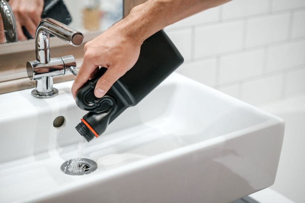 clean-bathroom-basin-drain-with-cleaners