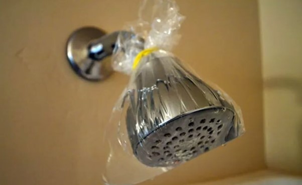 cleaning shower head using coke
