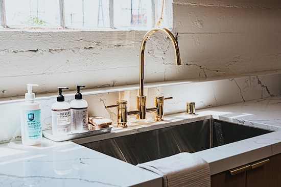 industrial countertop with gold plated faucet