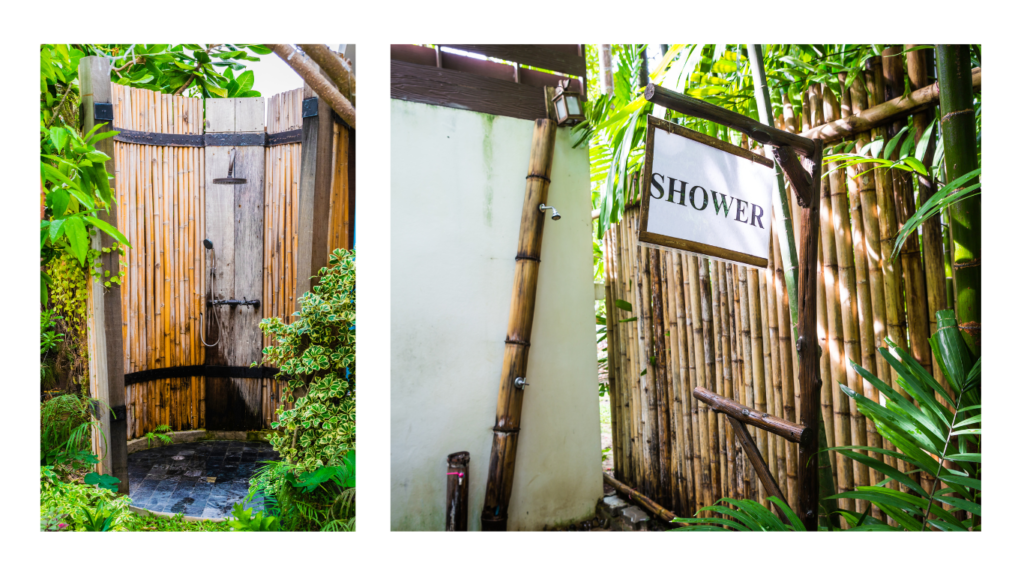 Outdoor shower with live plants as privacy screen and freestanding bathtub