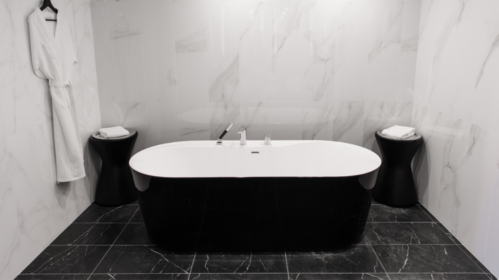 black bathtub with white and black tiles